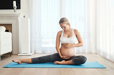 Buy stock photo Shot of a pregnant woman meditating on an exercise mat at home