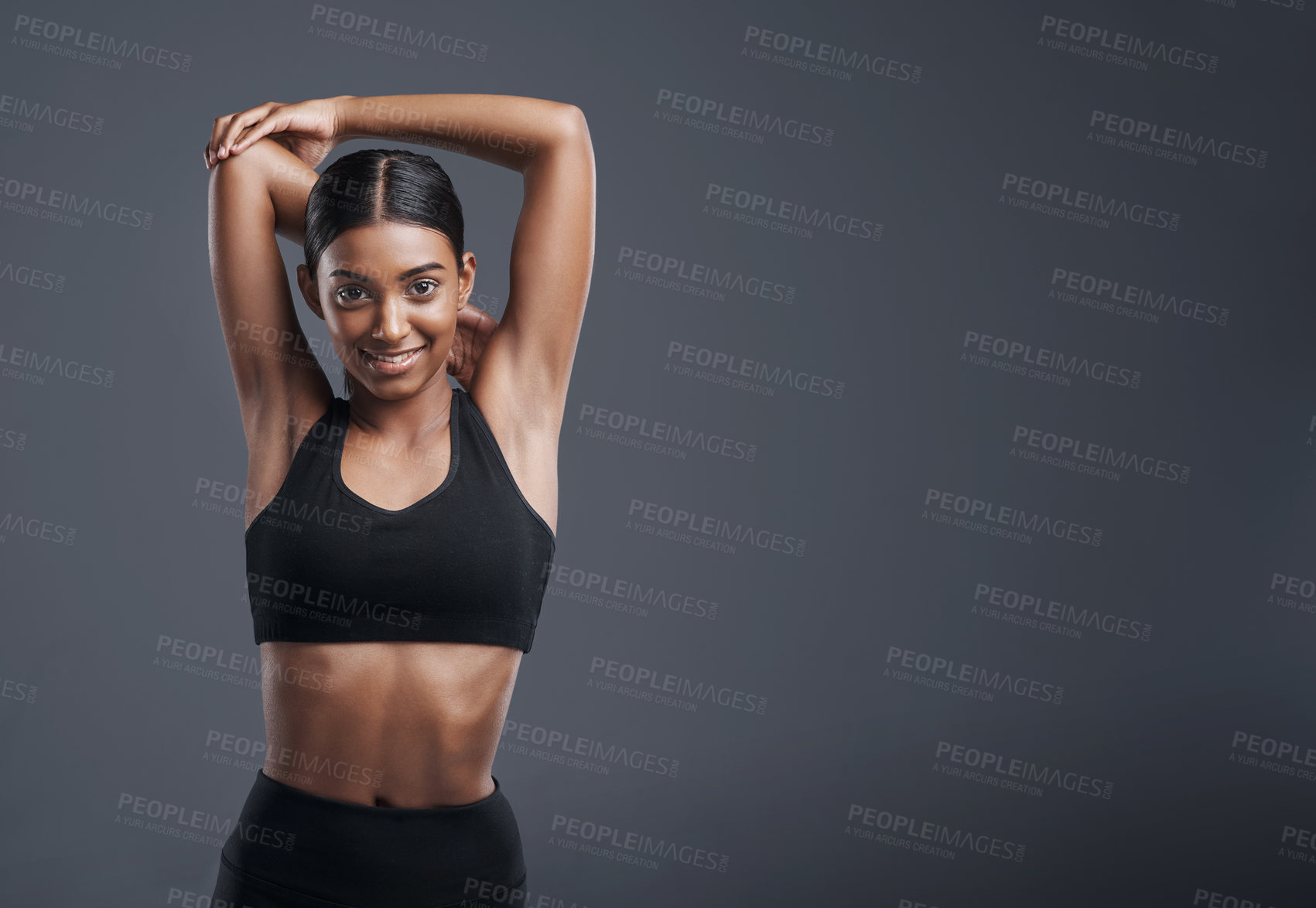 Buy stock photo Portrait, mockup and stretching with an athlete woman in studio on a gray background for fitness or health. Exercise, workout and warm up with an attractive young female model training her body