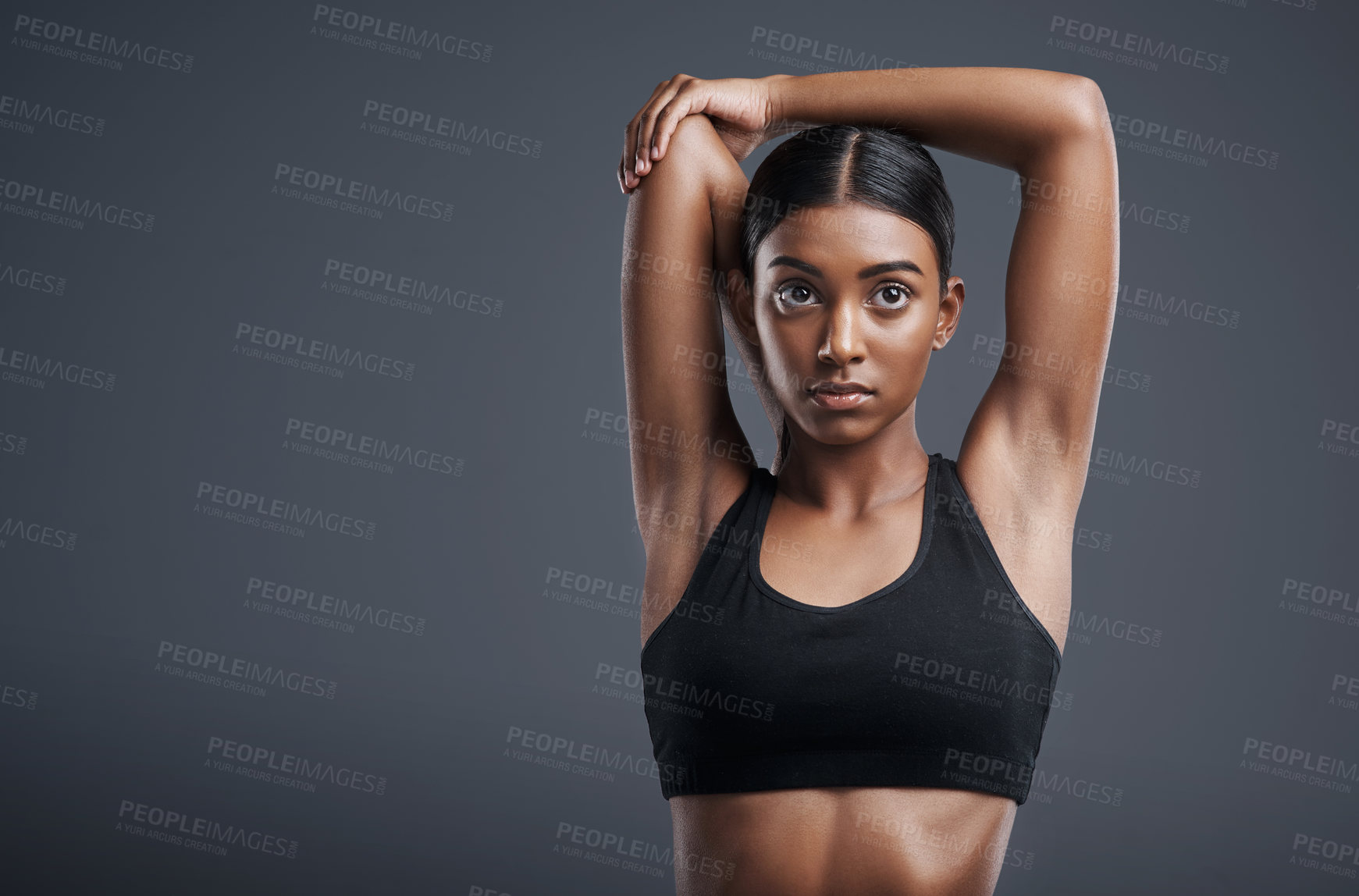 Buy stock photo Thinking, fitness and stretching with an athlete woman in studio on a gray background for health on mockup. Exercise, idea and warm up with an attractive young female model training her body