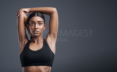 Buy stock photo Fitness, wellness and stretching with an athlete woman in studio on a gray background for mindset or health. Exercise, mission and warm up with an attractive young female model training on mockup