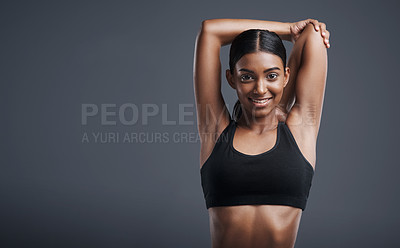 Buy stock photo Portrait, mockup and stretching with an athlete woman in studio on a gray background for fitness or health. Exercise, workout and warm up with an attractive young female model training her body