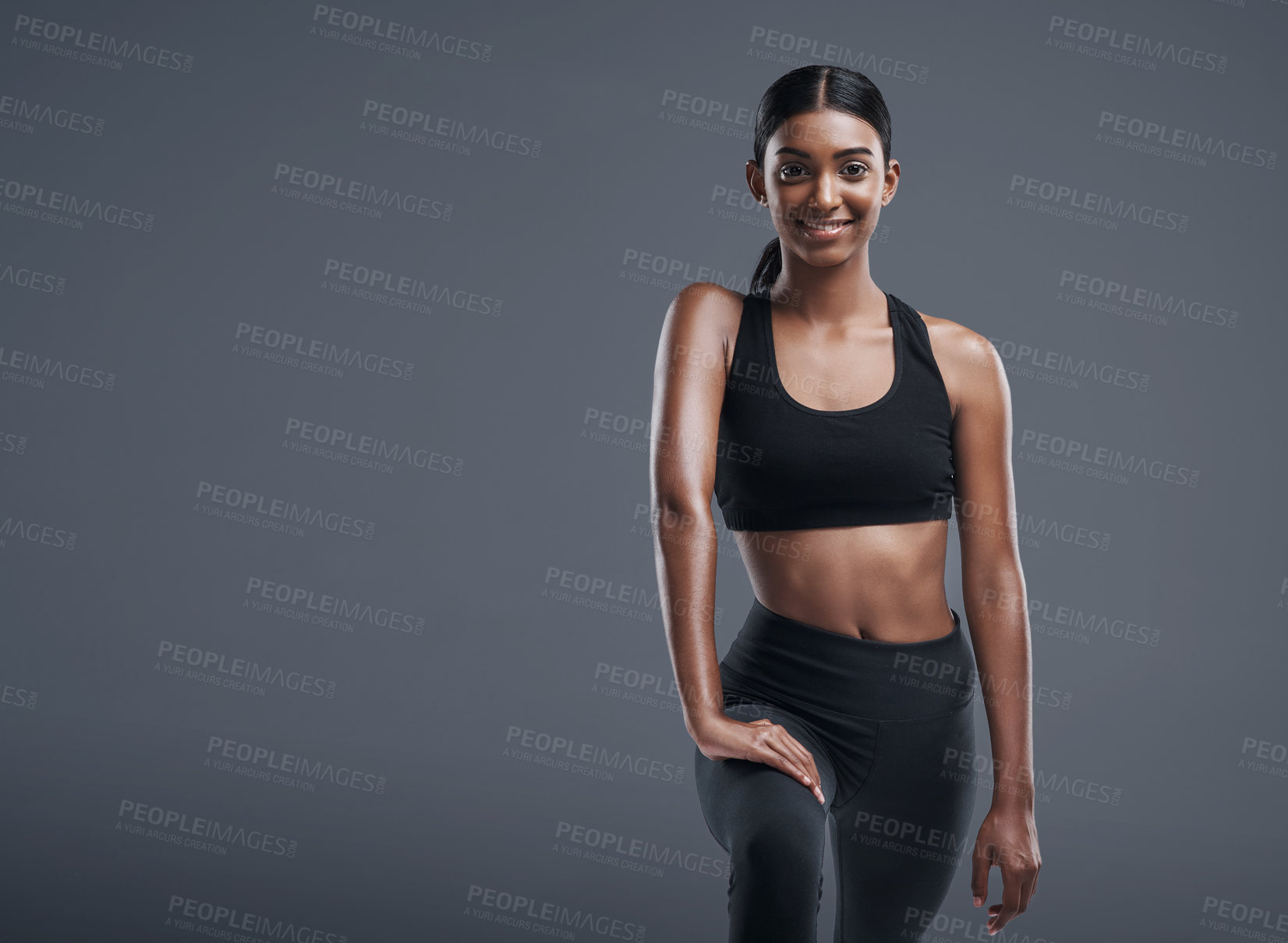 Buy stock photo Studio portrait of a sporty young woman posing against a gray background