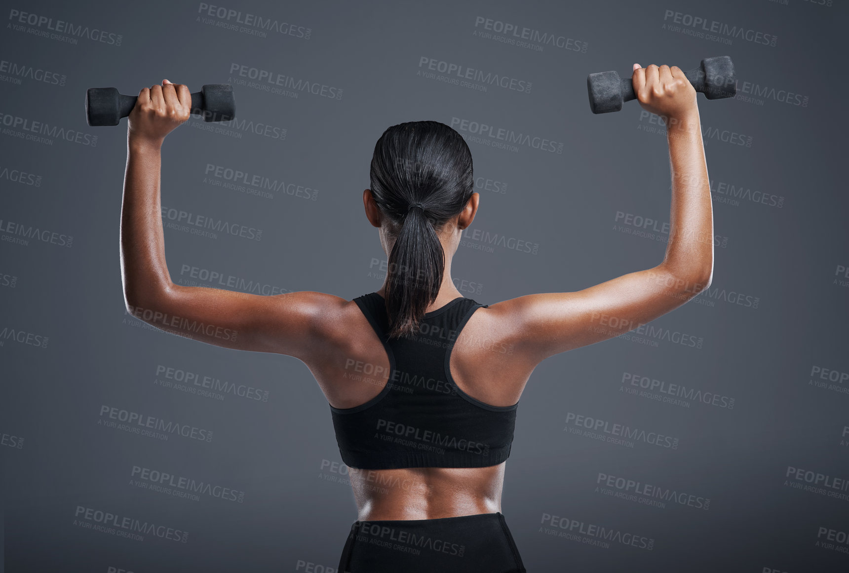 Buy stock photo Back, fitness and woman with dumbbell in studio for muscle workout, training and healthy body. Sports, person and athlete with equipment for cardio, strength exercise and wellness on gray background
