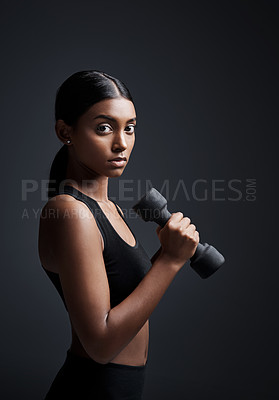 Buy stock photo Portrait, serious and woman with dumbbell for workout in studio isolated on a black background. Strong, bodybuilder and Indian female athlete weightlifting for muscle, training and fitness exercise.