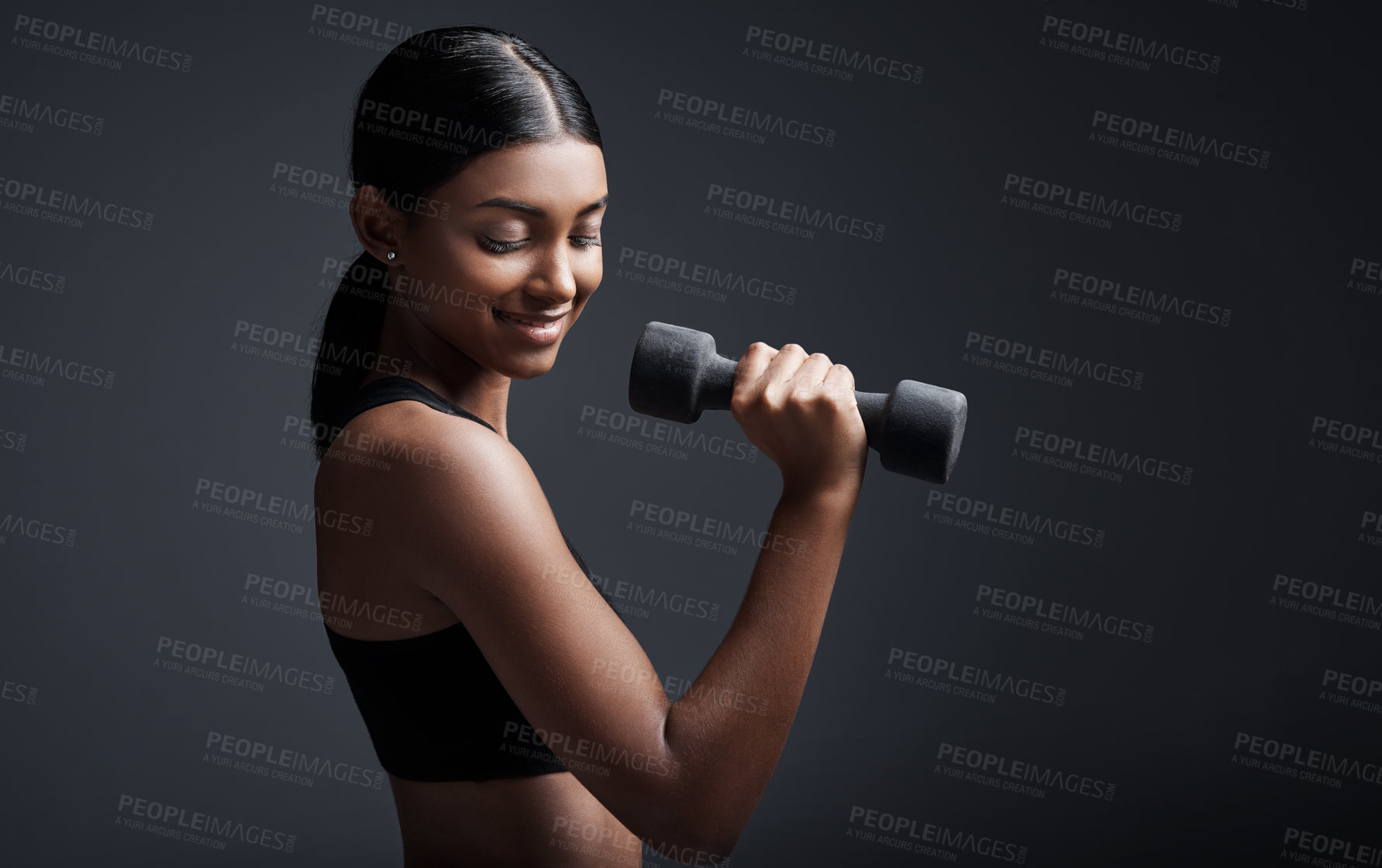 Buy stock photo Indian woman, dumbbells and smile for exercise in studio for training on black background, lose weight or mockup. Female person, weightlifting and gym fitness for bicep muscle, wellness or challenge