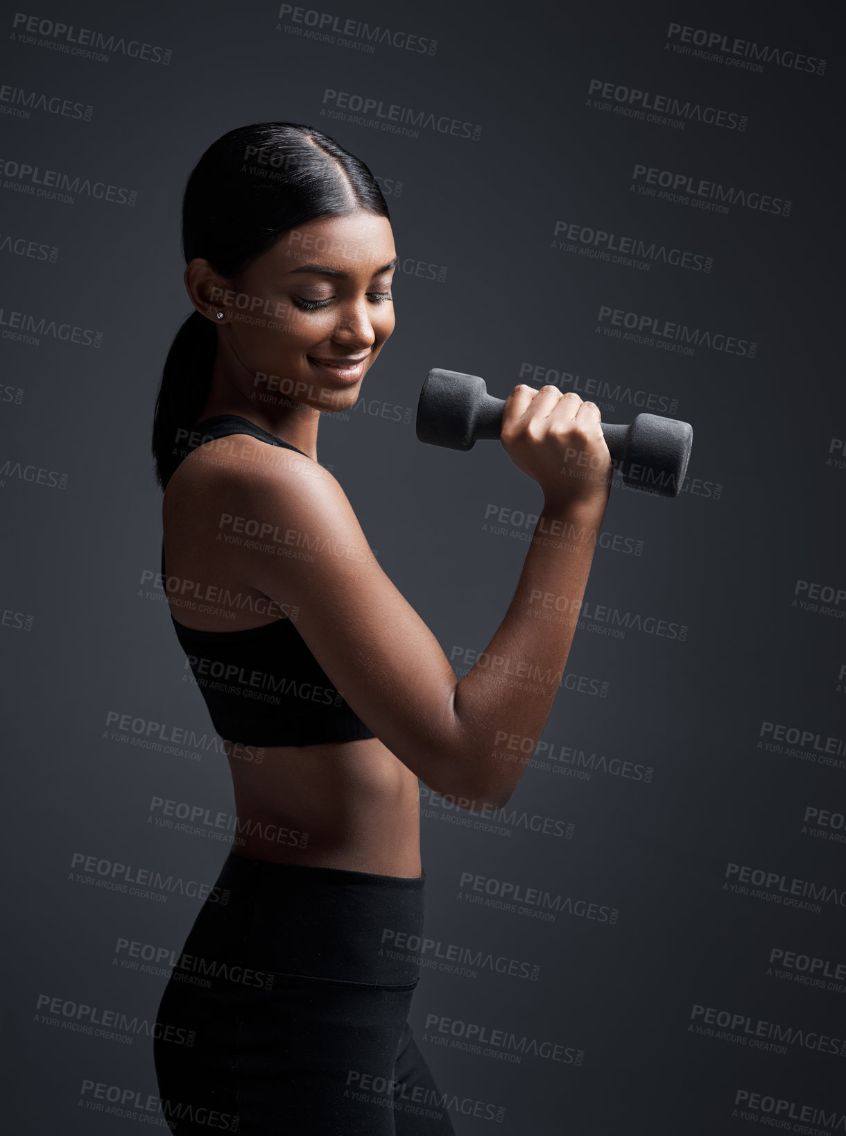 Buy stock photo Indian woman, dumbbells and smile for fitness in studio for training on black background, lose weight or mockup. Female person, weightlifting and gym confidence or bicep muscle, wellness or challenge