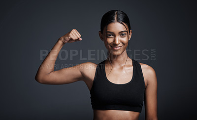 Buy stock photo Portrait, smile and woman flexing muscle in studio isolated on black background. Strong, happy and Indian female athlete with bicep, arm strength and bodybuilder workout, fitness or sports exercise.
