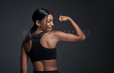 Buy stock photo Wink, happy and woman flexing muscle in studio isolated on a black background mockup. Strong flex, funny and Indian female athlete with bicep, arm strength or bodybuilder back, fitness or workout.