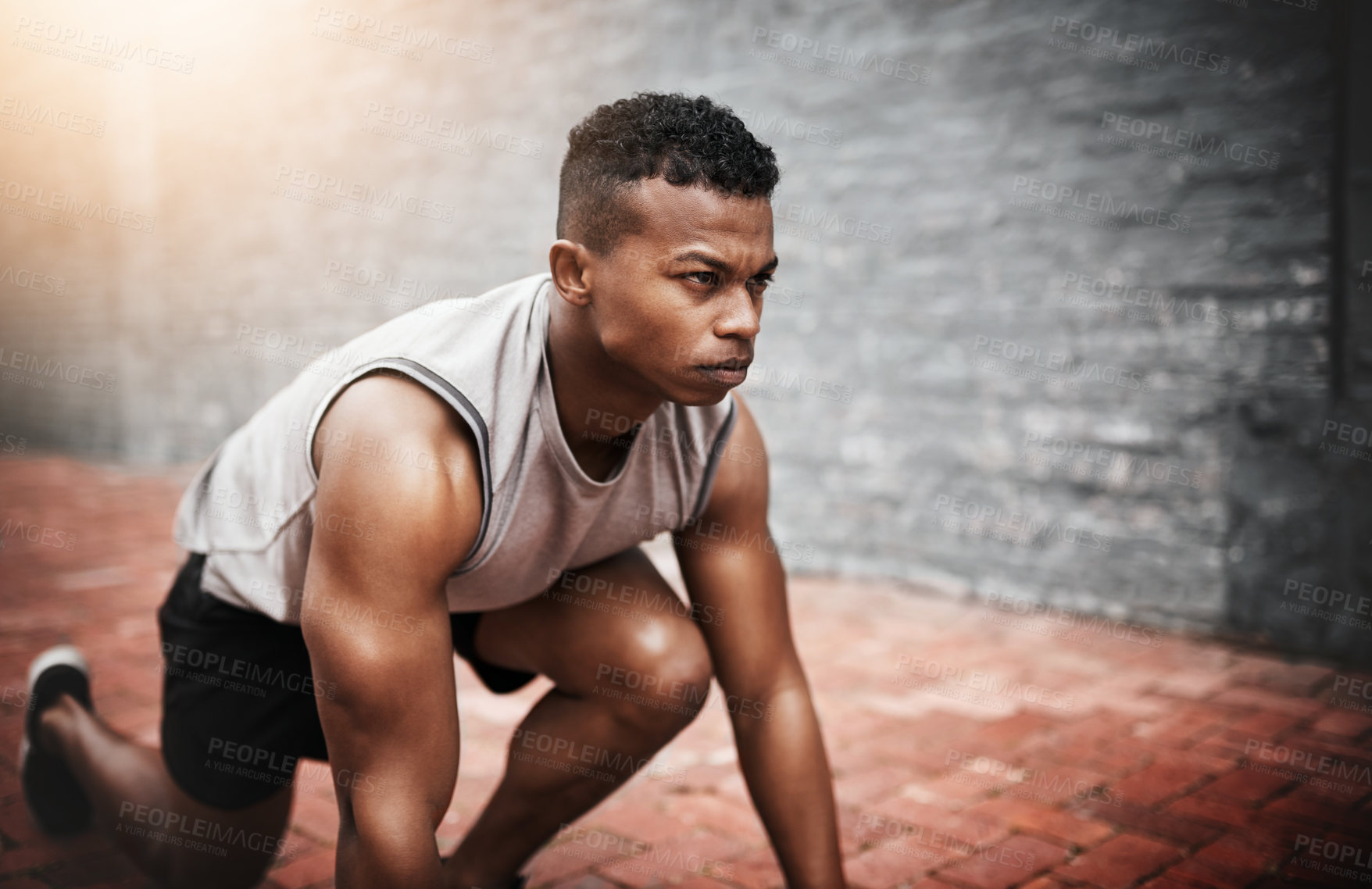 Buy stock photo Shot of a sporty young man exercising outdoors