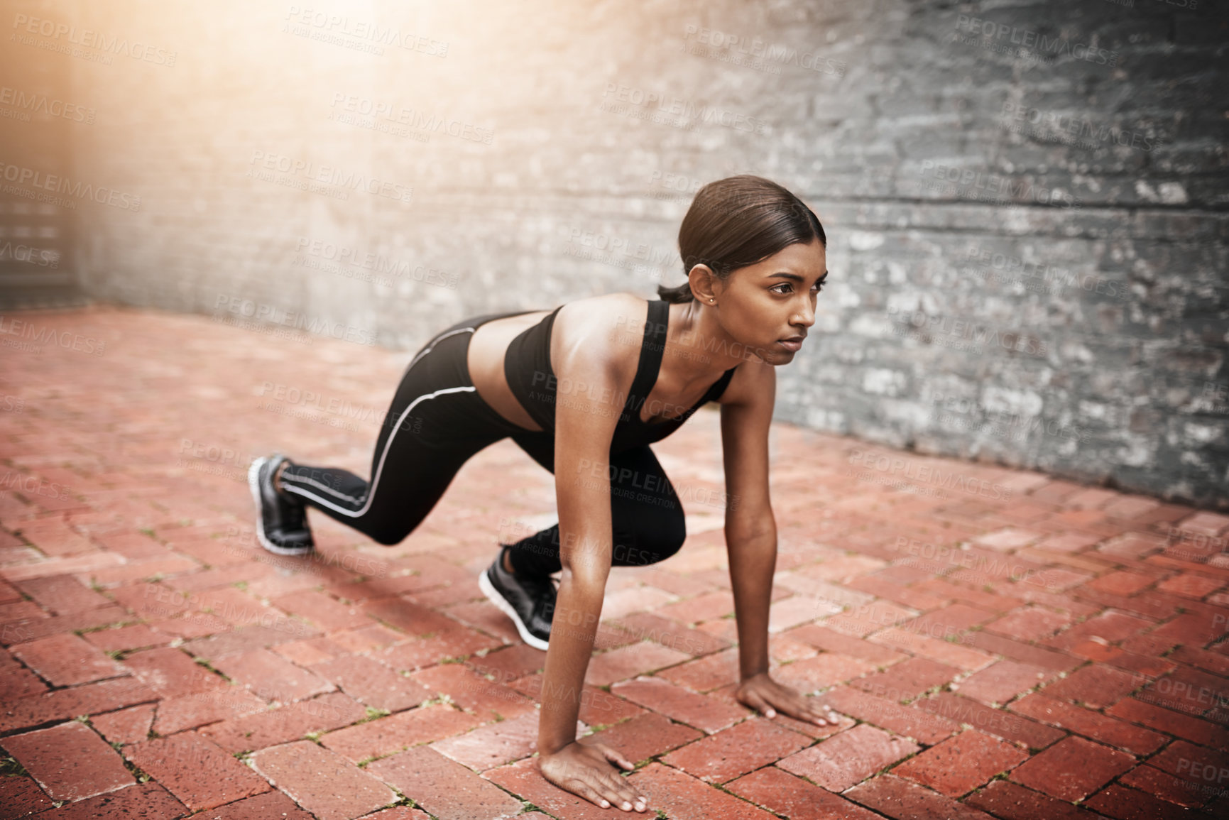 Buy stock photo Indian woman, fitness and start position outdoor for cardio, stretching and exercise in city. Gen z runner, wellness and training in urban area for athlete, competition and race for sports or health