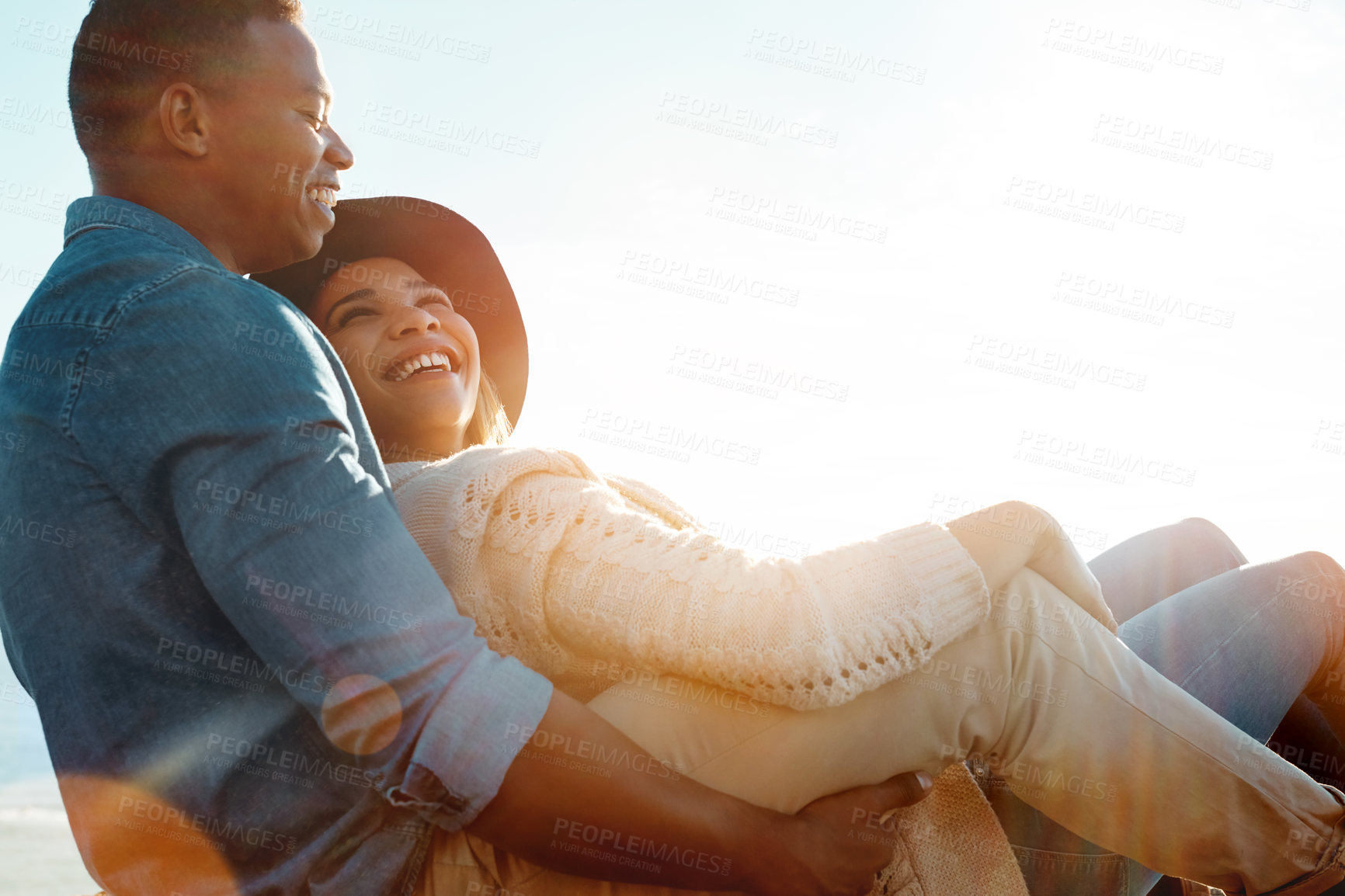 Buy stock photo Shot of a happy young couple enjoying a romantic day outdoors