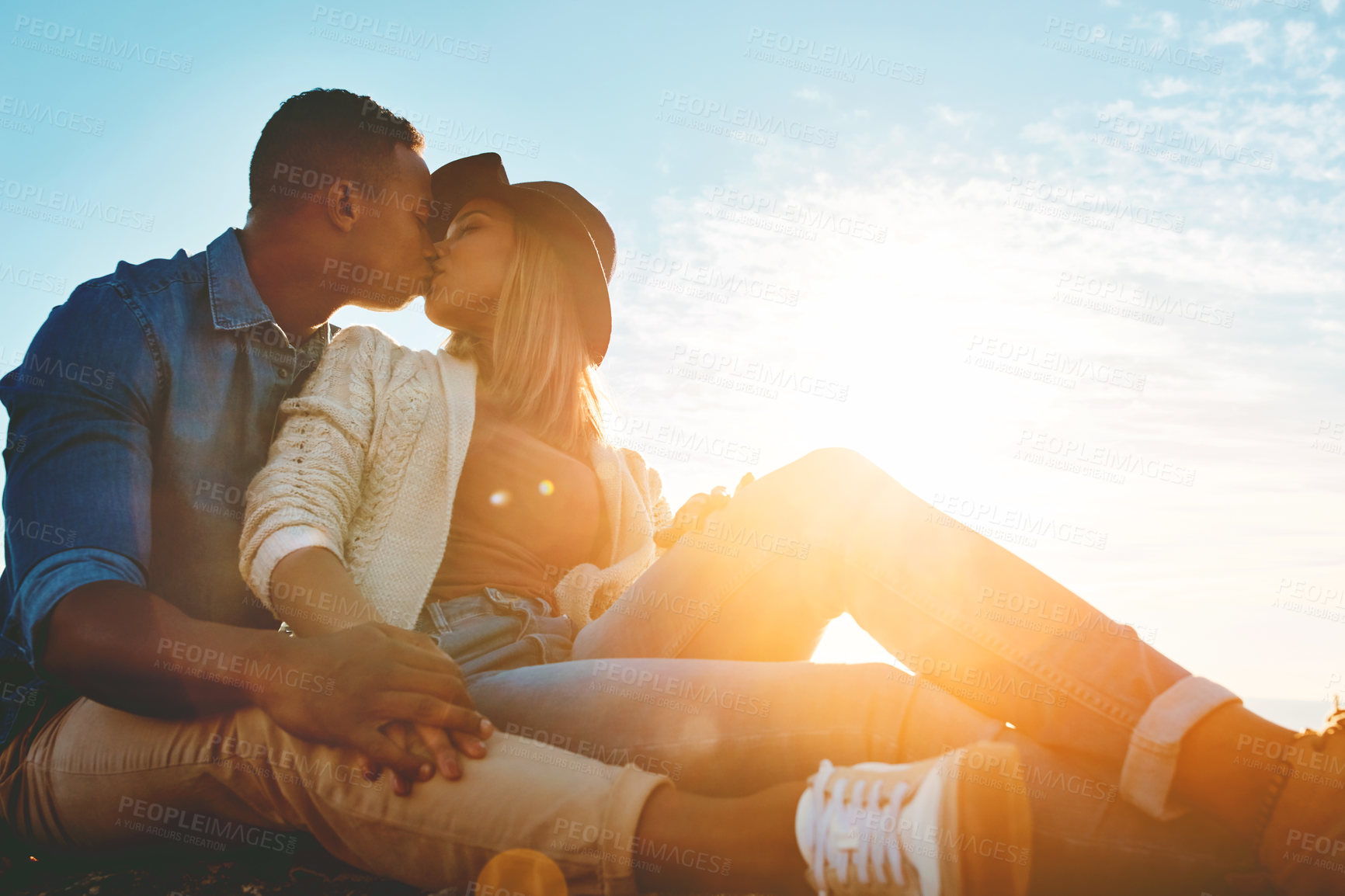 Buy stock photo Shot of a happy young couple enjoying a romantic day outdoors