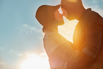 Buy stock photo Shot of a happy young couple sharing a romantic moment outdoors