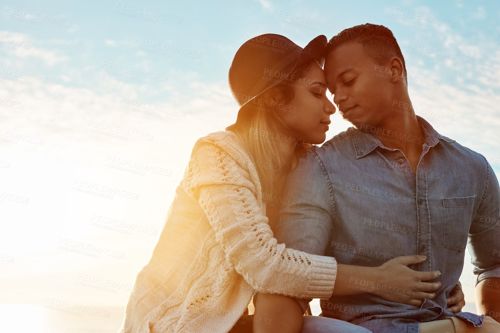 Buy stock photo Shot of a happy young couple enjoying a romantic day outdoors