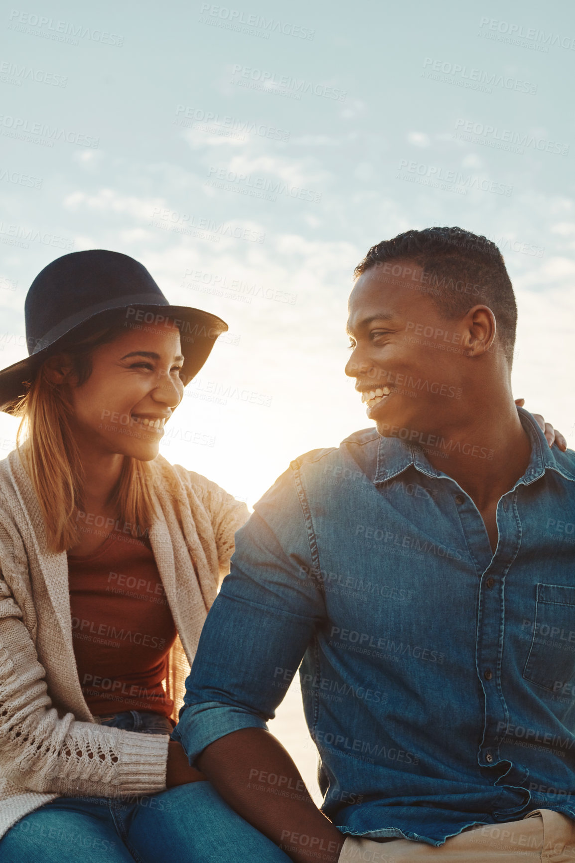 Buy stock photo Shot of a happy young couple enjoying a romantic day outdoors