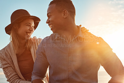 Buy stock photo Shot of a happy young couple enjoying a romantic day outdoors