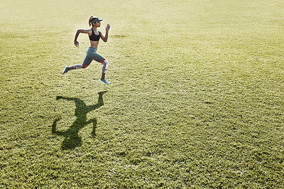 Buy stock photo Full length shot of an attractive and athletic young woman running across an open field