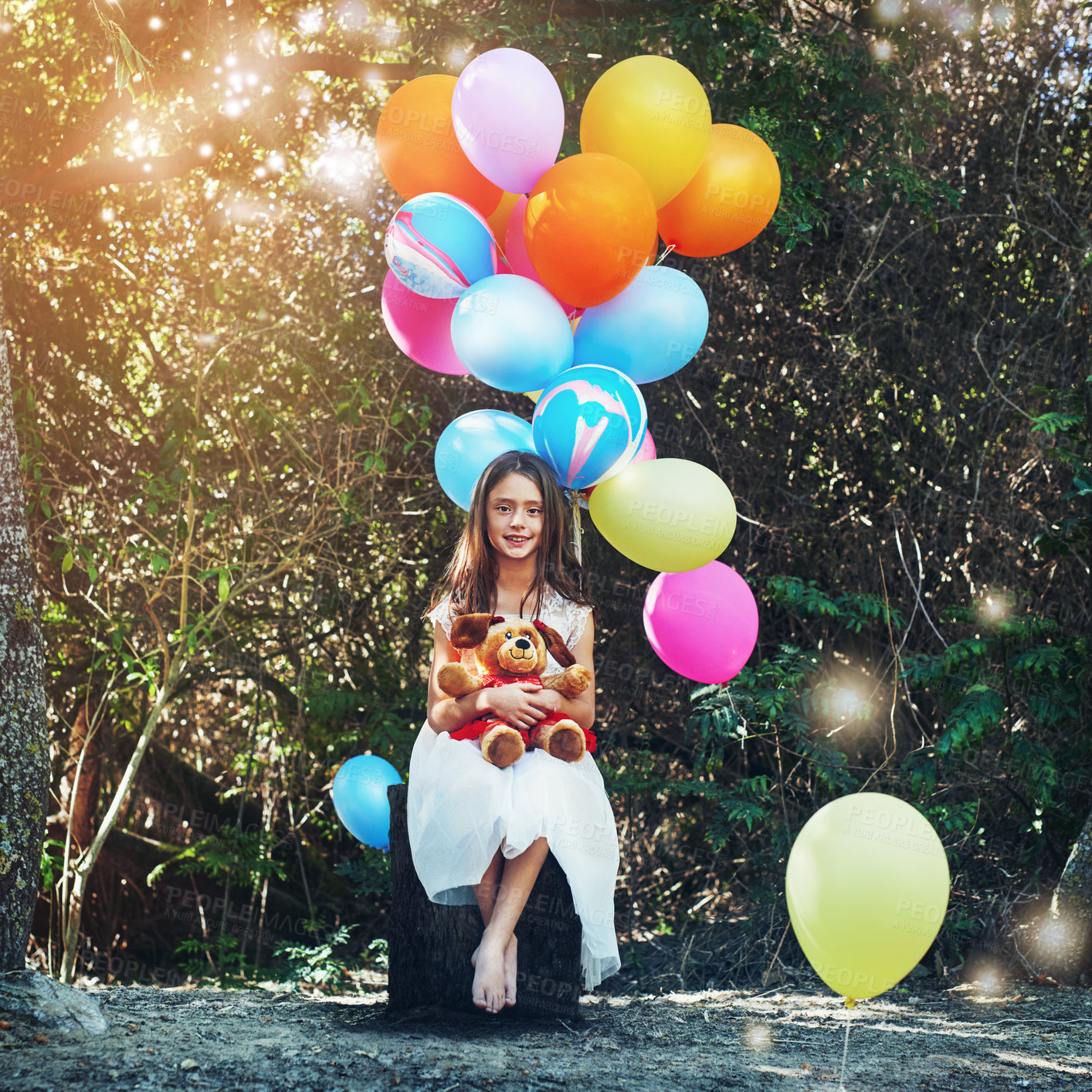 Buy stock photo Portrait of a little girl playing with a teddybear and bunch of balloons outside
