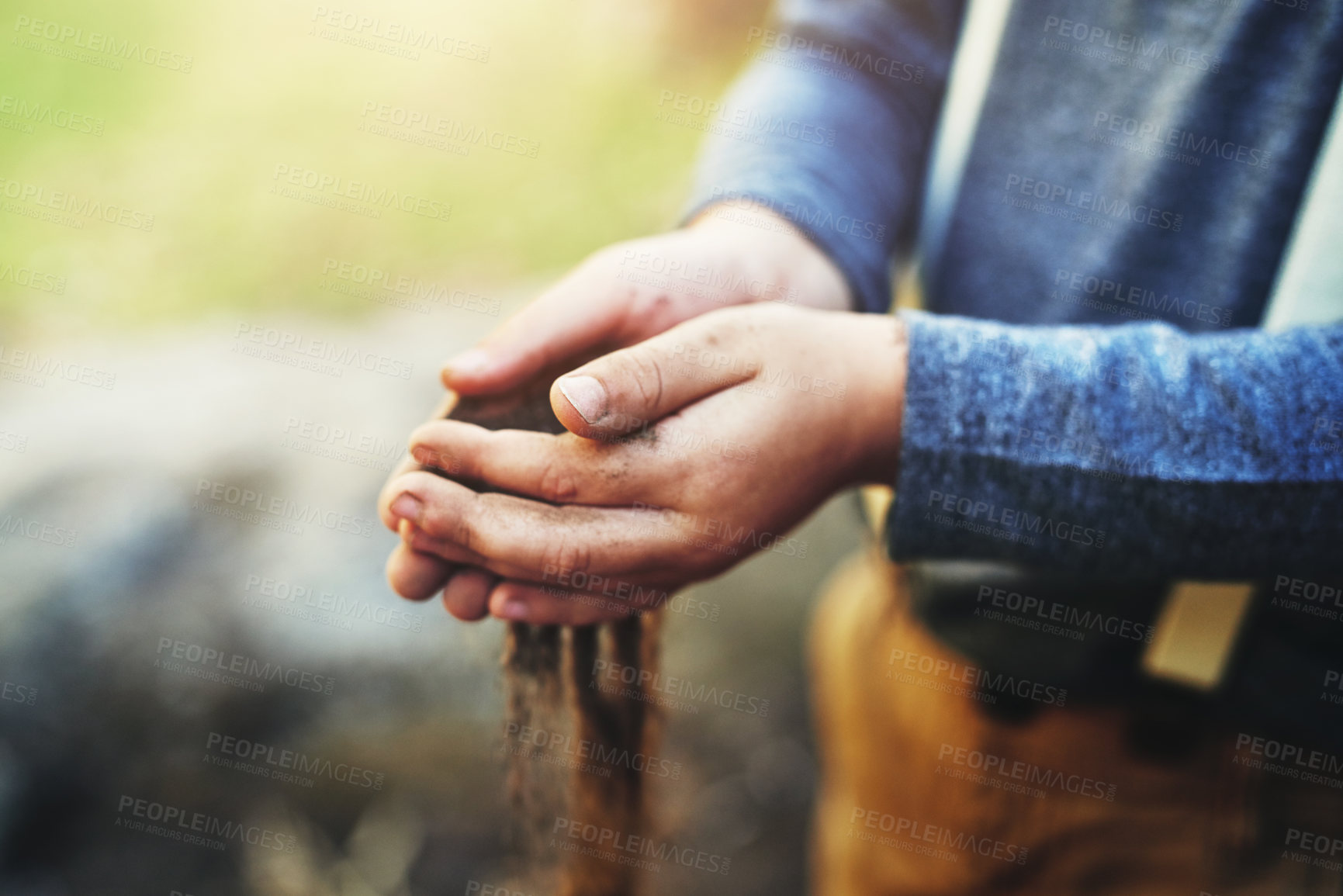 Buy stock photo Closeup shot of a little boy holding soil in his hands