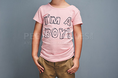 Buy stock photo Studio shot of a boy wearing a t shirt with “I’m a boy” printed on it against a gray background