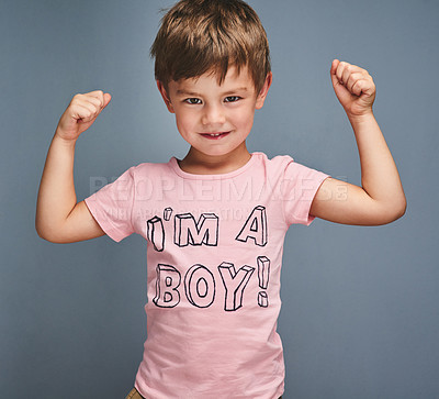 Buy stock photo Studio portrait of a cheering boy wearing a shirt with “I’m a boy” printed on it against a grey background