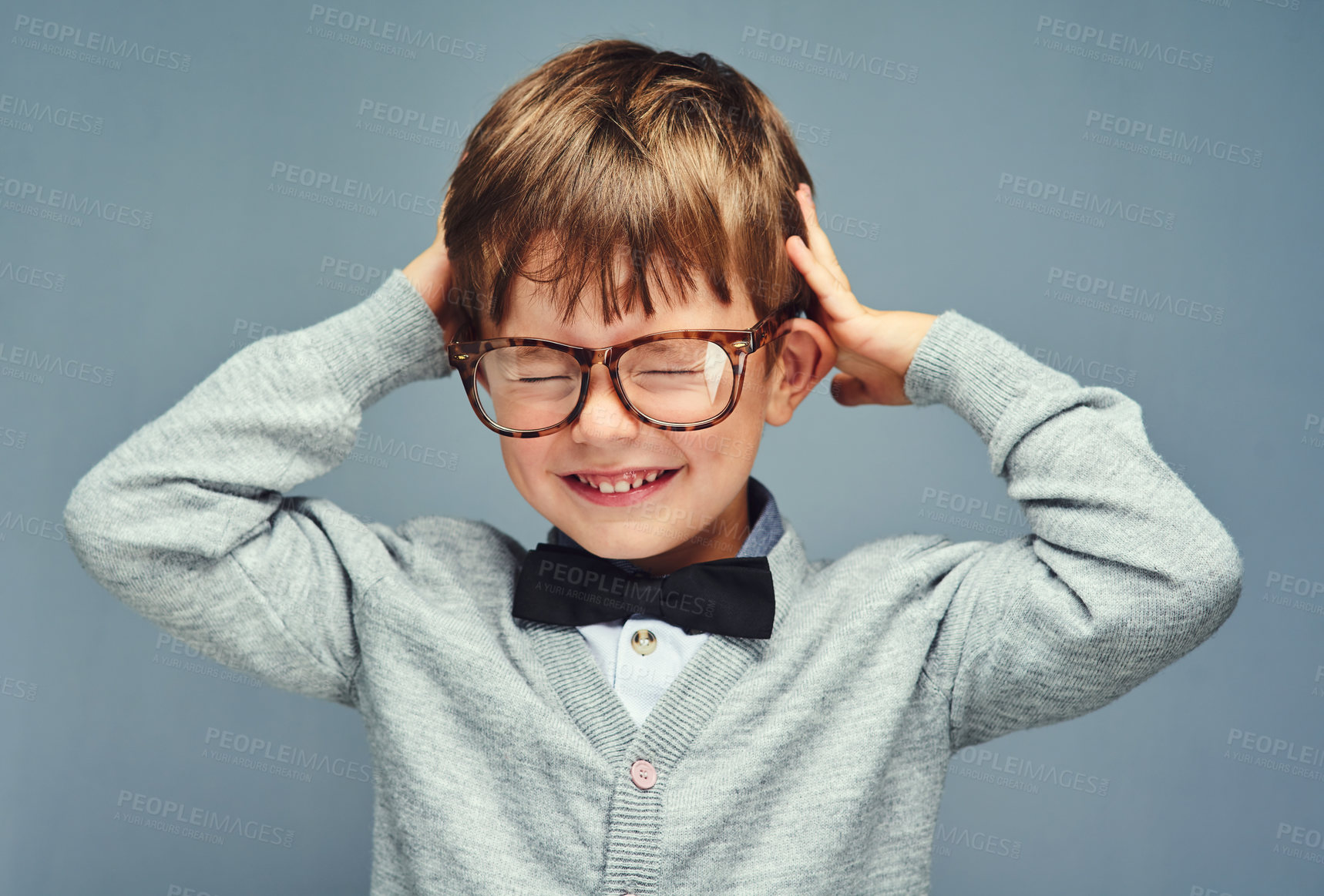 Buy stock photo Studio portrait of an adorable little boy dressed smartly against a gray background