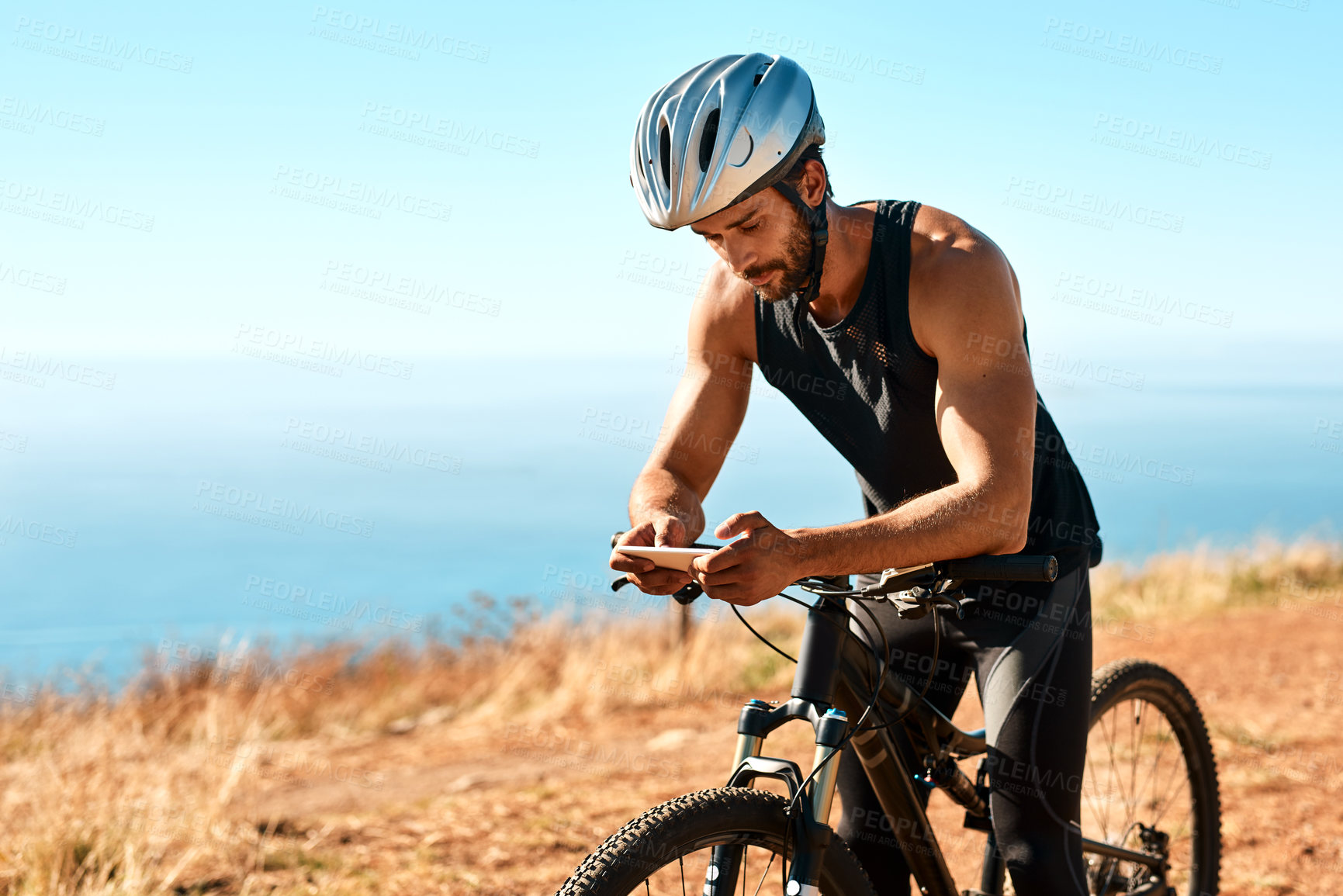 Buy stock photo Outdoor, smartphone and man with mountain bike for fitness, adventure or prepare for competition. Nature, male cyclist or bicycle with mobile for social media, chat or training for marathon challenge