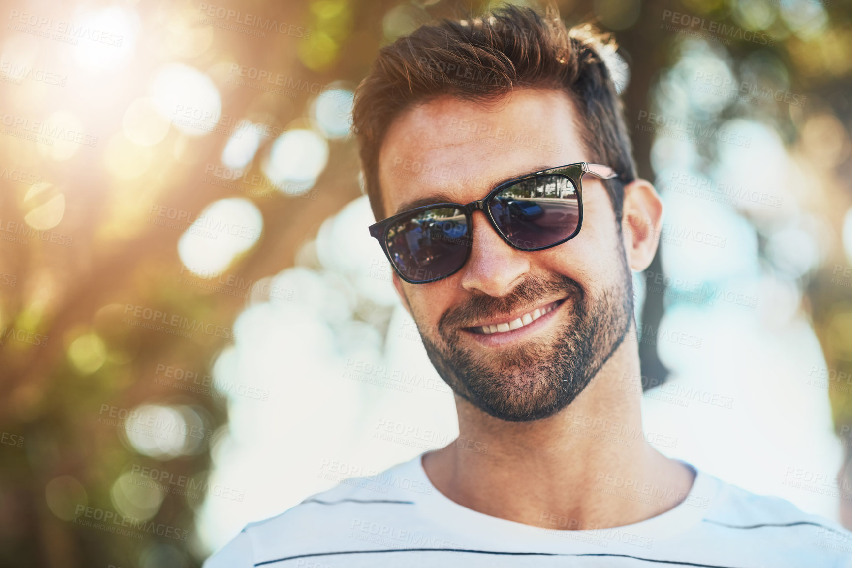Buy stock photo Sunglasses, casual and portrait of a happy man in an outdoor park while on a vacation, adventure or holiday. Smile, confidence and young male person with eyewear standing in a garden on weekend trip.