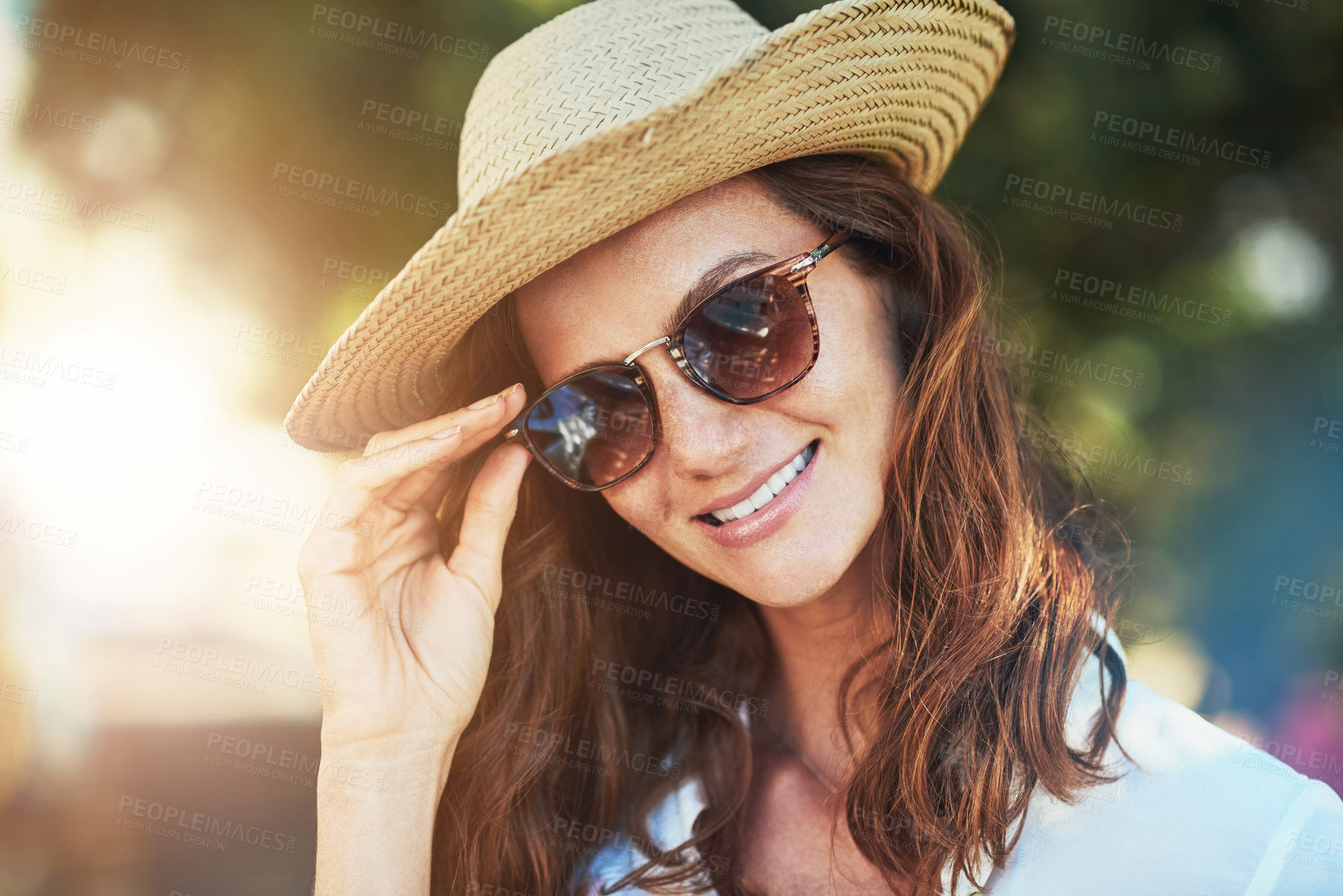 Buy stock photo Cropped portrait of an attractive young woman enjoying a summer’s day outdoors