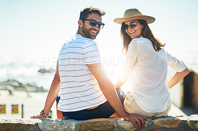 Buy stock photo Rearview portrait of a happy young couple enjoying a summer’s day outdoors