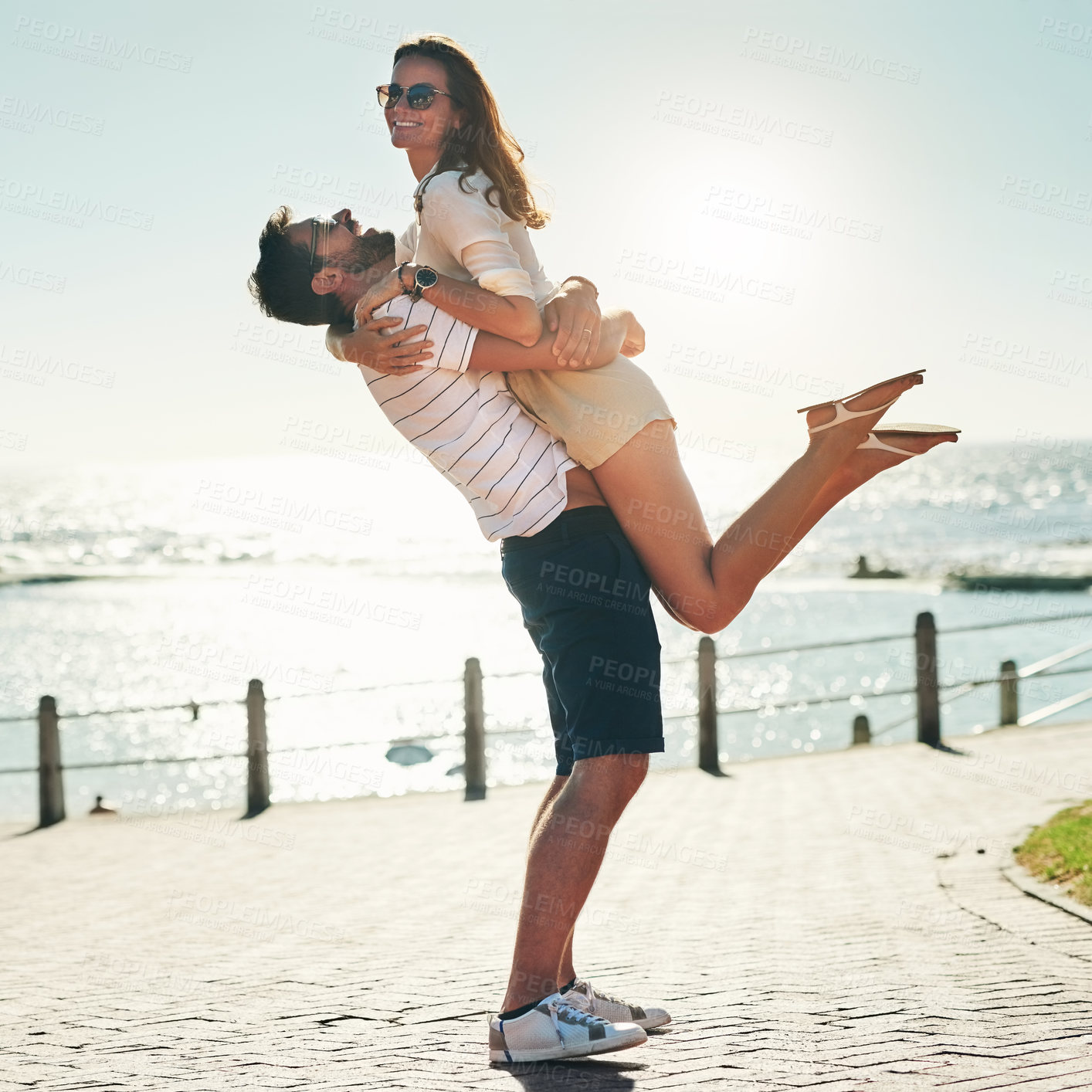 Buy stock photo Full length shot of a happy young couple embracing on a summer’s day outdoors