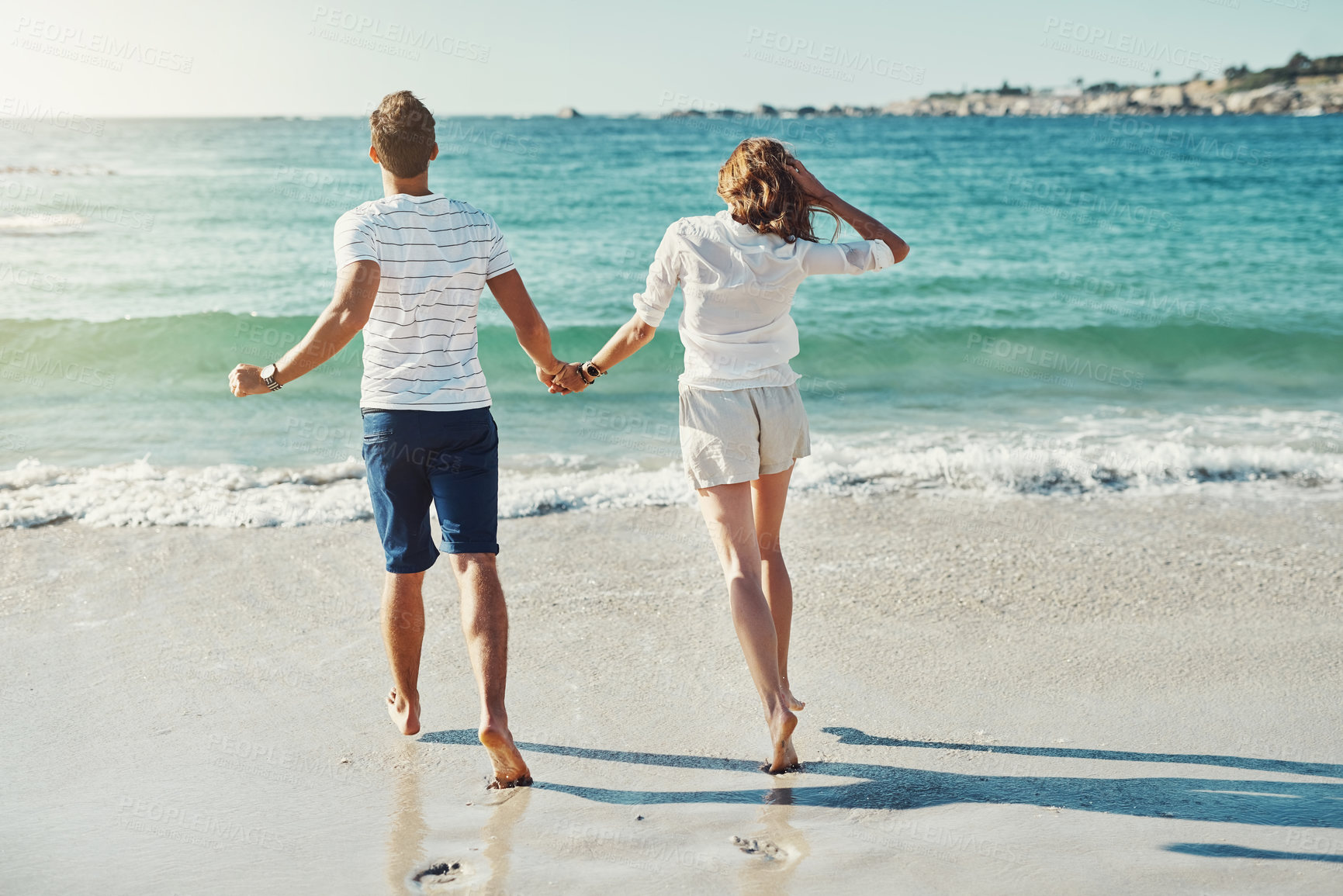 Buy stock photo Beach, holding hands and couple with love, running and vacation for honeymoon, romance and journey. Marriage, seaside and man with woman, lens flare and adventure with support, summer and travelling