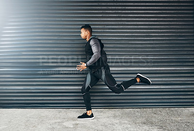 Buy stock photo Shot of a sporty young man running against a grey background