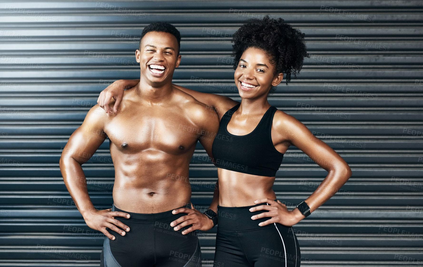 Buy stock photo Portrait of a sporty young couple standing together against a grey background