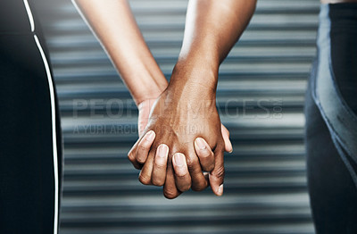 Buy stock photo Closeup shot of a sporty couple holding hands against a grey background