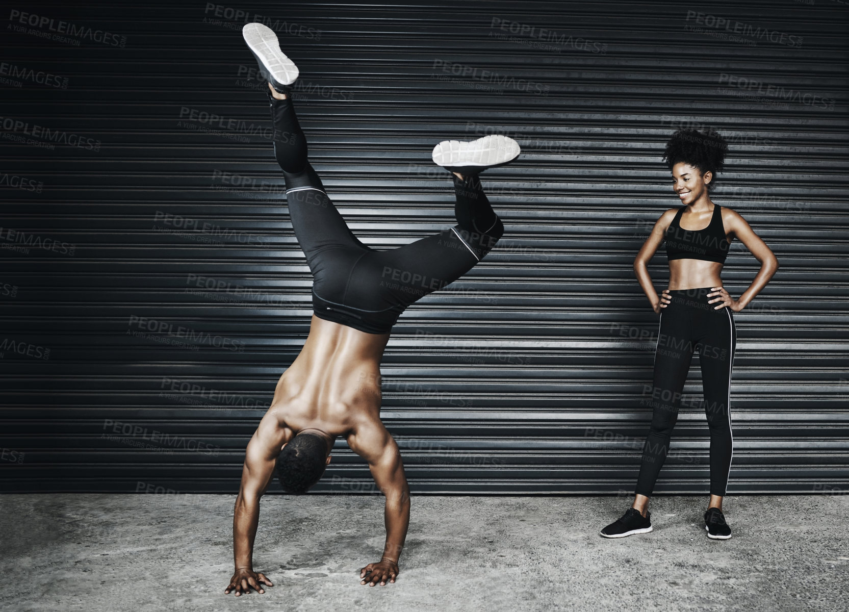 Buy stock photo Shot of a sporty young couple exercising against a grey background