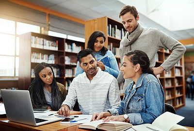 Buy stock photo Cropped shot of a group of university students studying in the library