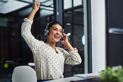 Buy stock photo Cropped shot of an attractive young businesswoman cheering while working late in a call center