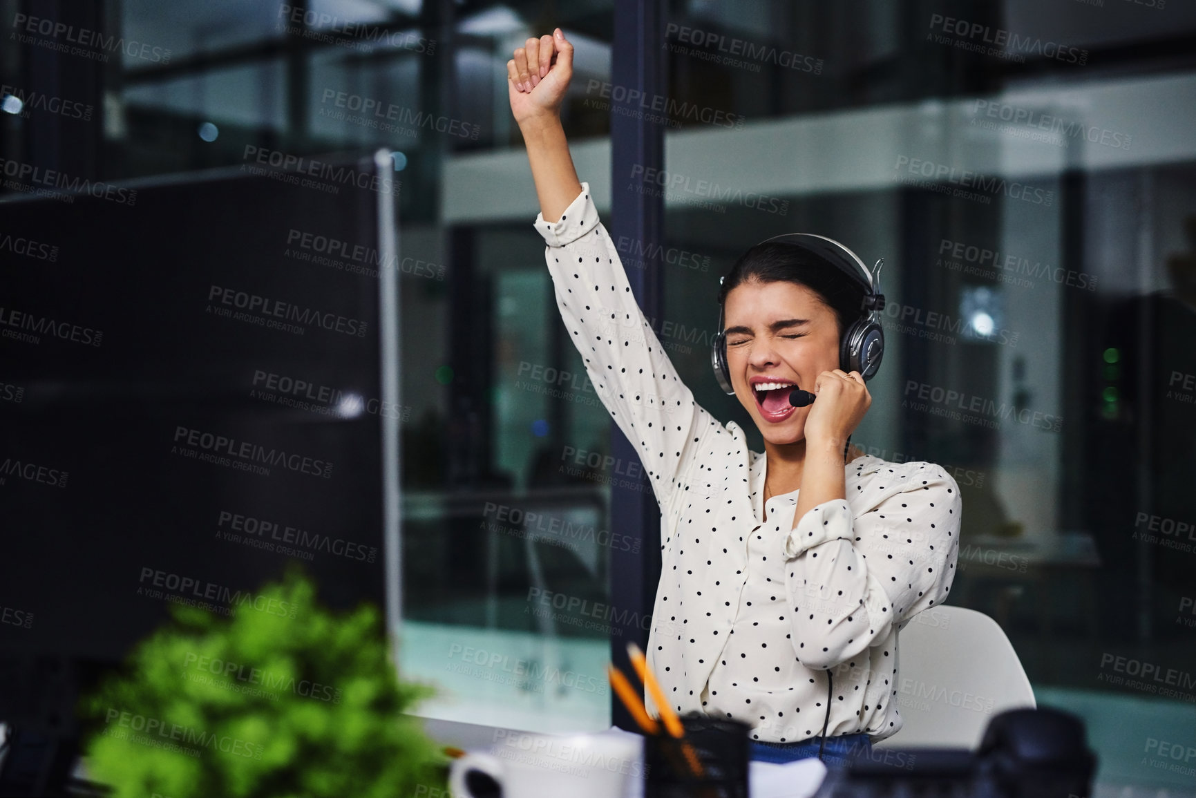 Buy stock photo Cropped shot of an attractive young businesswoman cheering while working late in a call center