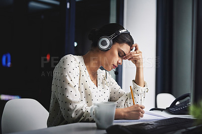 Buy stock photo Cropped shot of an attractive young businesswoman looking stressed while working late in a call center