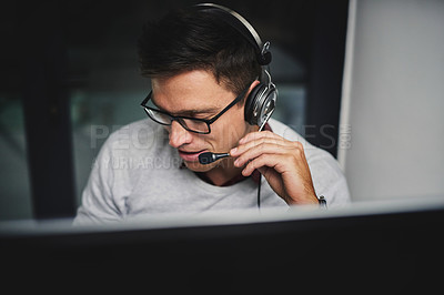 Buy stock photo Cropped shot of a handsome young businessman working late in a call center