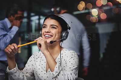 Buy stock photo Cropped shot of an attractive young woman looking thoughtful while working in a call center