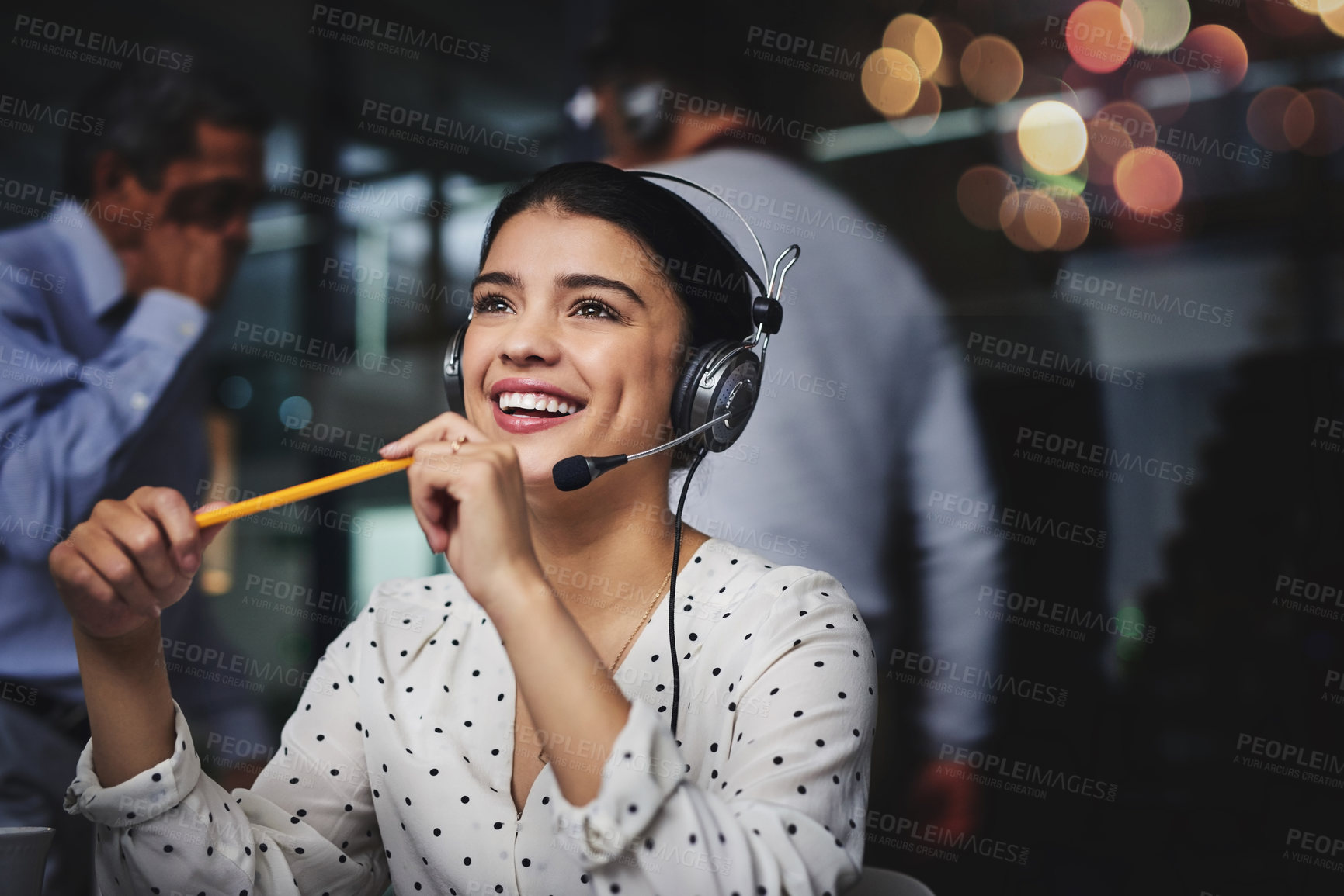 Buy stock photo Cropped shot of an attractive young woman looking thoughtful while working in a call center