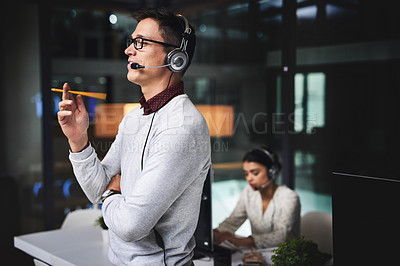 Buy stock photo Man, call center and listening with smile at night in office, thinking or problem solving for tech support. Person, agent and virtual consultant with voip headset, telemarketing and customer service