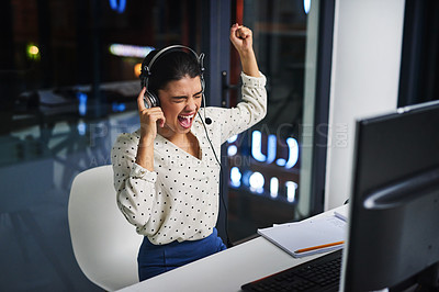 Buy stock photo Cropped shot of an attractive young woman cheering  while working in a call center