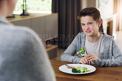 Buy stock photo Disgust, vegetable and fear with child and broccoli for nutrition, health and cooking. Sad, angry and dinner with boy and refuse to eat food at home for eating problem, frustrated and dislike