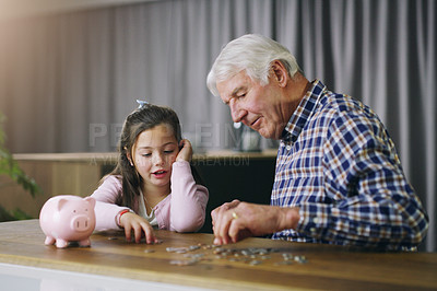 Buy stock photo Money, piggy bank and help with child and grandfather for savings, investment and learning. Growth, cash and future with young girl and old man in family home for generations, finance and support