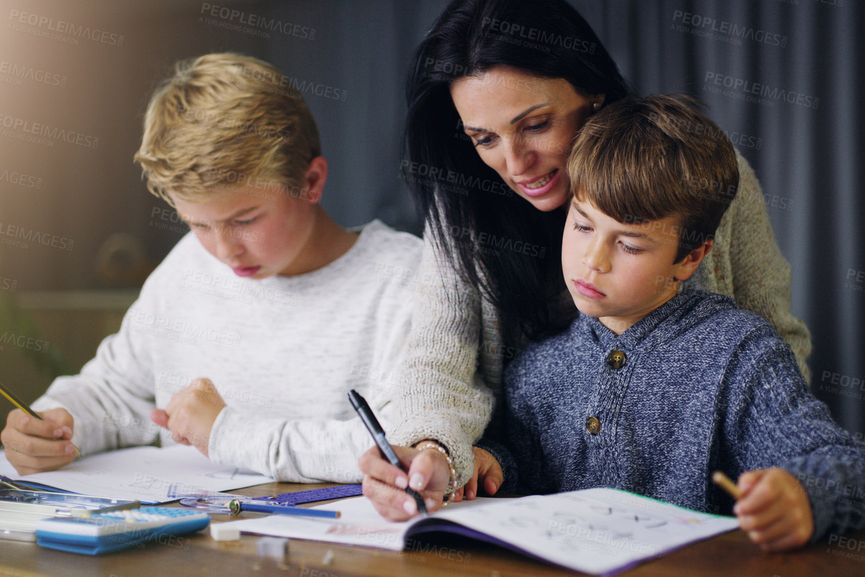 Buy stock photo Mother, children and helping with school homework in house or learning education, teaching or lesson. Woman, sons and table in apartment for student knowledge or academic studying, writing or project