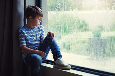 Buy stock photo Boy child, rain and sad by window with thinking, mental health and space for mockup in home. Male kid, raining and think by glass with depression, mock up or bored with problem, winter or frustration