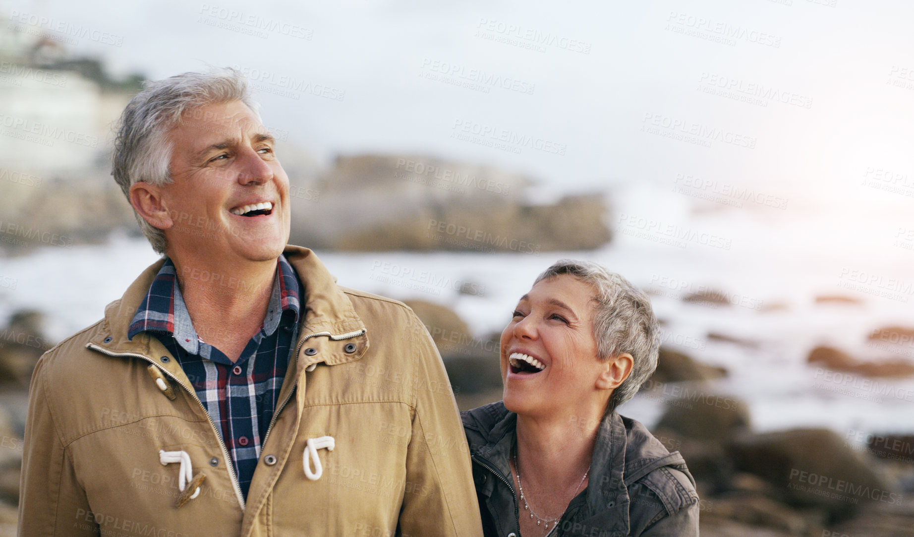 Buy stock photo Shot of a beautiful elderly couple taking a walk at the beach